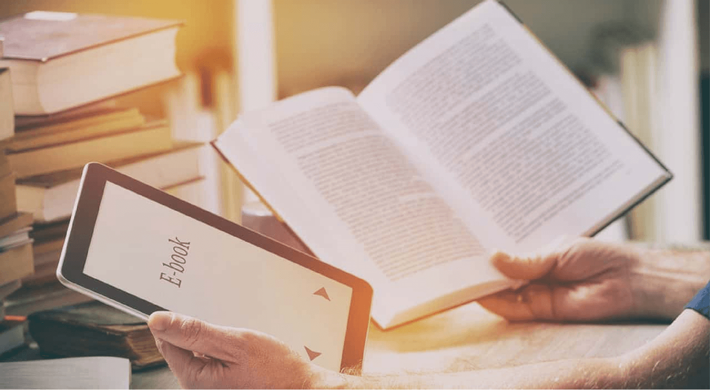 Hands holding an e-reader and open print book for digital and print publishing